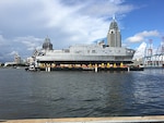 The future USNS Yuma (EPF 8) transits the Mobile river on a launch barge in preparation for its ceremonial launch at Austal USA shipyard, Sept. 16. 