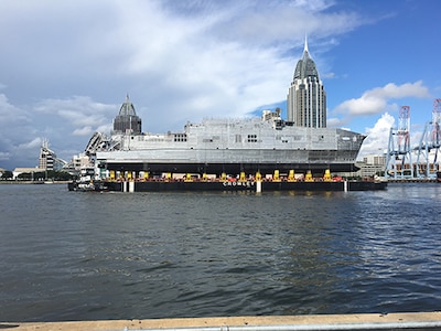 The future USNS Yuma (EPF 8) transits the Mobile river on a launch barge in preparation for its ceremonial launch at Austal USA shipyard, Sept. 16. 