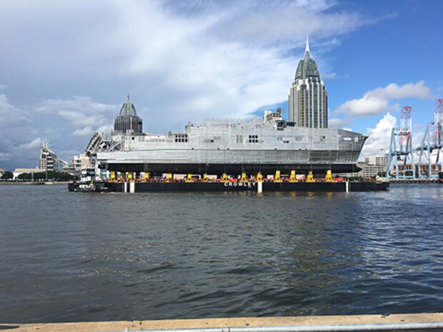 The future USNS Yuma (EPF 8) transits the Mobile river on a launch barge in preparation for its ceremonial launch at Austal USA shipyard, Sept. 16. 