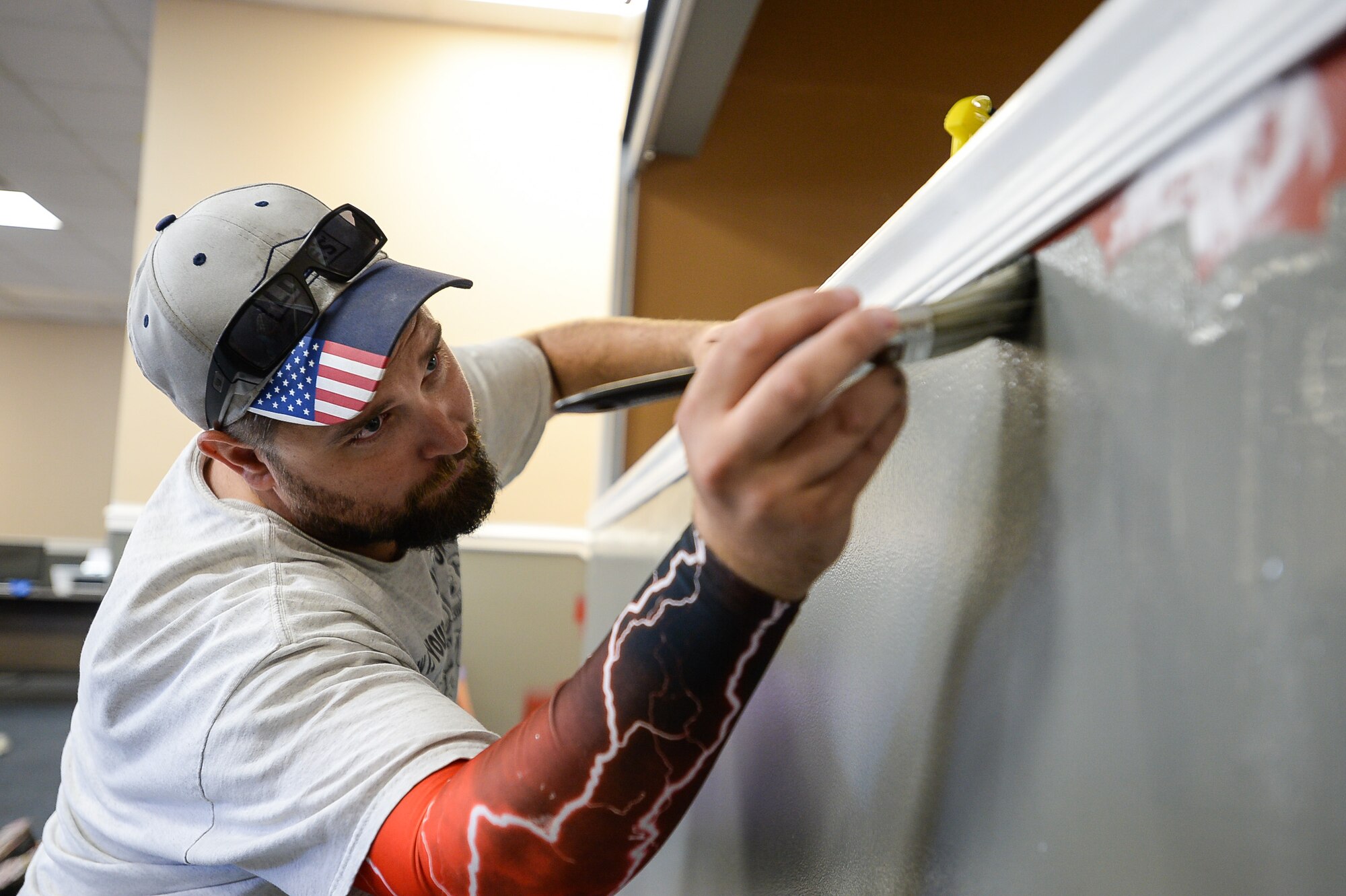 Layton Lowe’s employee Mike Rogers paints an edge in the Airman Recreation Center, Hill Air Force Base, Utah, during a community relations project, Sept. 13, 2016. (U.S. Air Force photo by R. Nial Bradshaw)