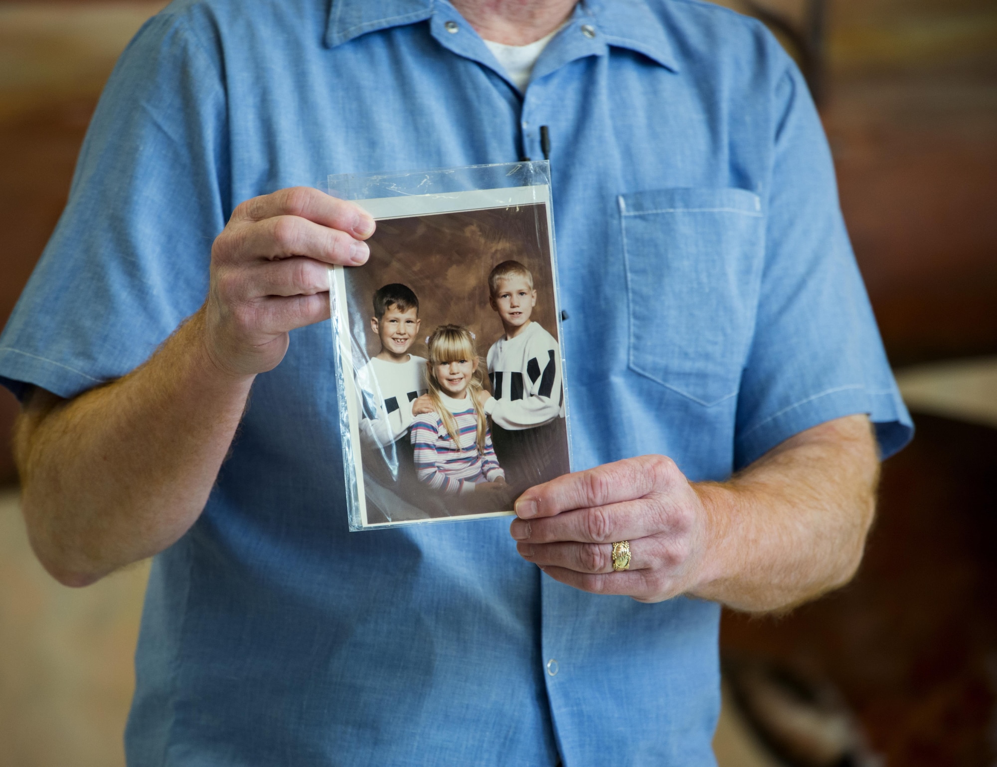 An inmate from the California Medical Facility shares a personal story about his incarceration and shows a photograph of his children during the time he was imprisoned at CMF, in Vacaville, Calif., Sept. 15, 2016. (U.S. Air Force photo by Staff Sgt. Charles Rivezzo)