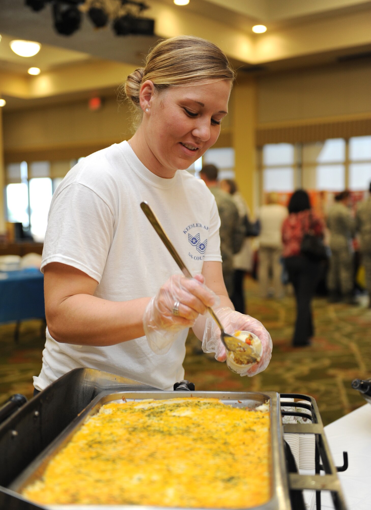 Tech. Sgt. Valerie Divert, 81st Training Wing wing executive support services NCO in charge, serves Sheppard’s Pie  to Keesler personnel during Diversity Day at the Bay Breeze Event Center Sept. 13, 2016, on Keesler Air Force Base, Miss. The cultural celebration included food sampling and information booths about countries around the world and other special emphasis groups. (U.S. Air Force photo by Kemberly Groue/Released)