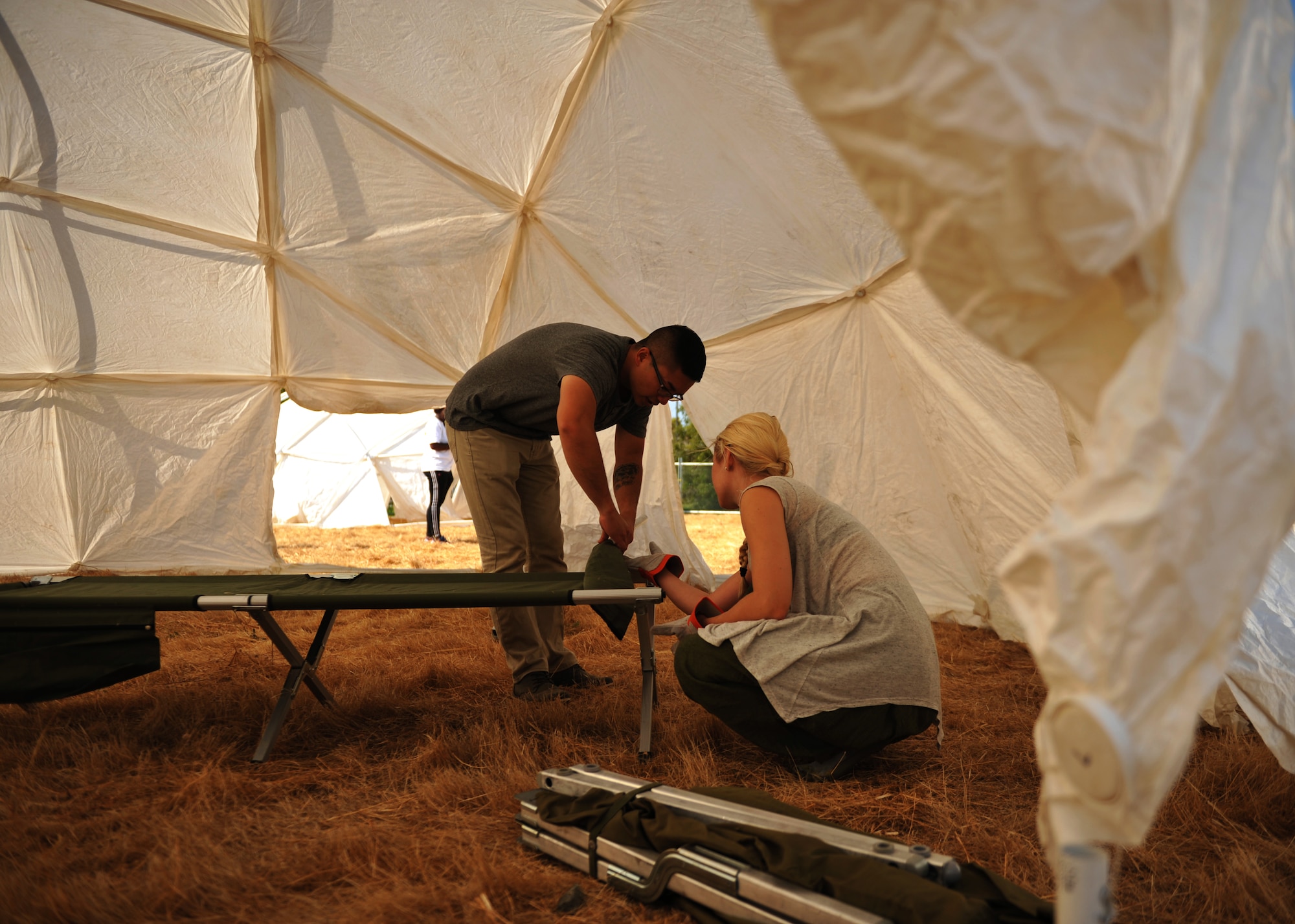 Volunteers from Travis Air Force Base construct cots for the three-day Sacramento Stand Down event Sept. 13, 2016, at Rancho Cordova, California. The Stand Down event is in its 25th year and provides shelter and multi-faceted assistance to homeless veterans in the Sacramento area. (U.S. Air Force photo/Staff Sgt. Jeffrey M. Schultze)