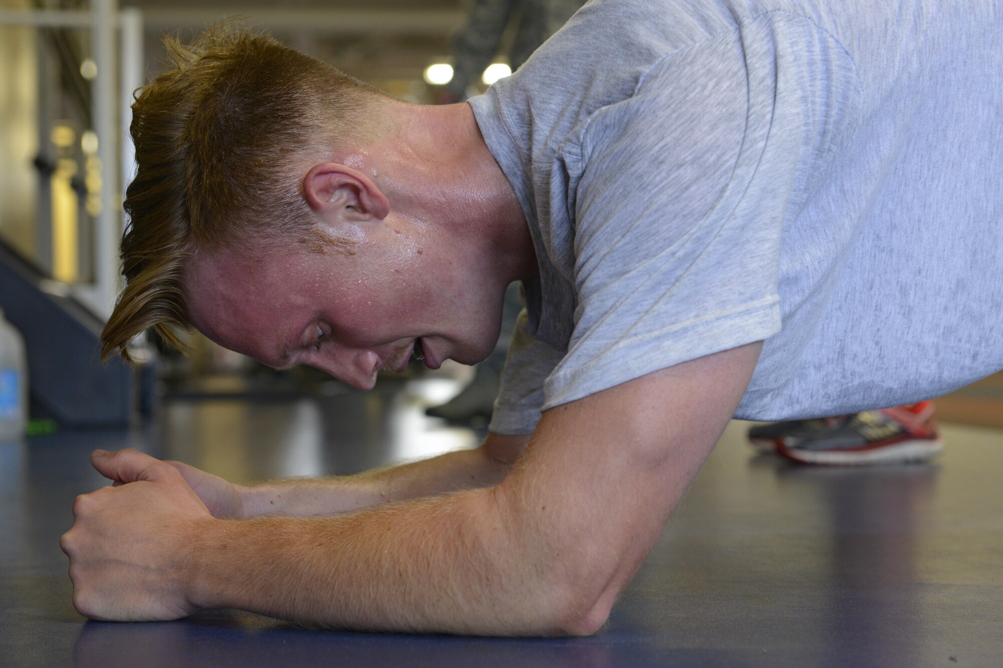 Senior Airman Christopher Bonham, with the 673d Security Forces Squadron, holds a plank at the Joint Base Elmendorf-Richardson Gym, Alaska, Sept. 6, 2016.  Bonham is part of a six-member team preparing to compete in the Pacific Air Forces Advanced Combat Skills Assessment hosted in Guam, Sept. 25 to 29, 2016. 