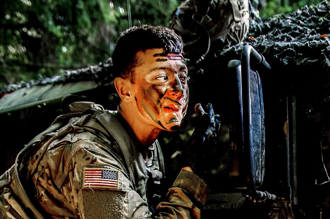 Army Spc. Cody Lucas applies camouflage paint before participating in defensive operations during exercise Combined Resolve 7 in Hohenfels, Germany, Sept. 11, 2016. Lucas is assigned to 1st Battalion, 41st Field Artillery Regiment, 1st Armored Brigade. Army photo by Pfc. Rachel Wilridge  