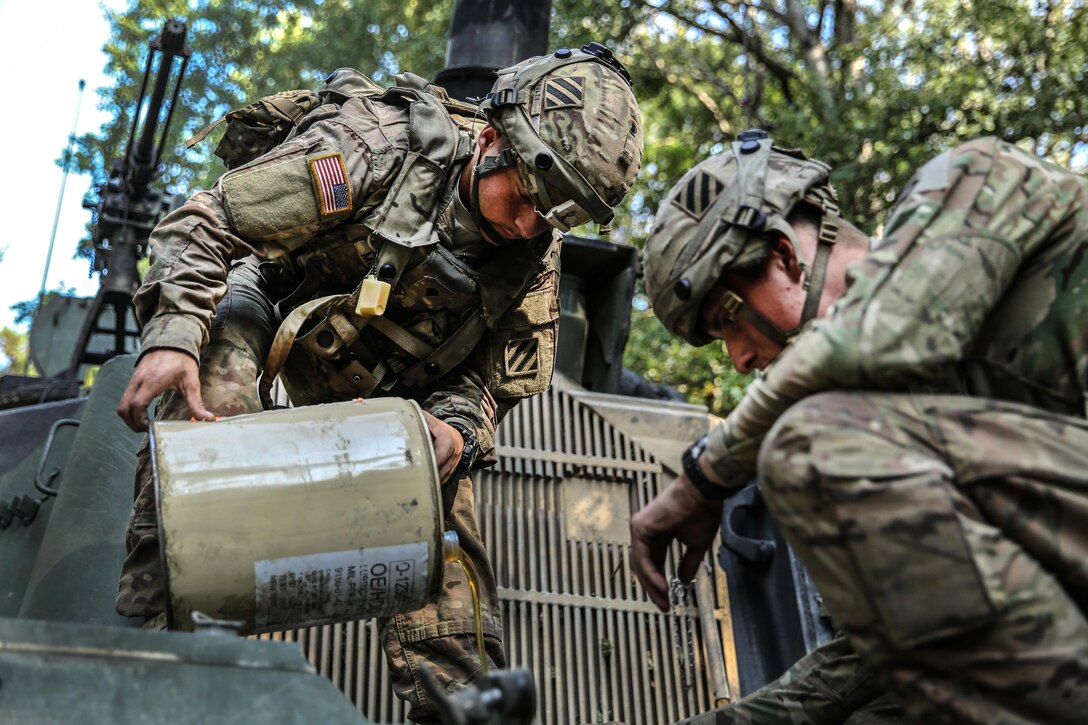 U.S. soldiers pour oil into a M109A6 Paladin howitzer during a resupply operation as part of exercise Combined Resolve VII in Hohenfels, Germany, Sept. 11, 2016. Army photo by Pfc. Rachel Wilridge