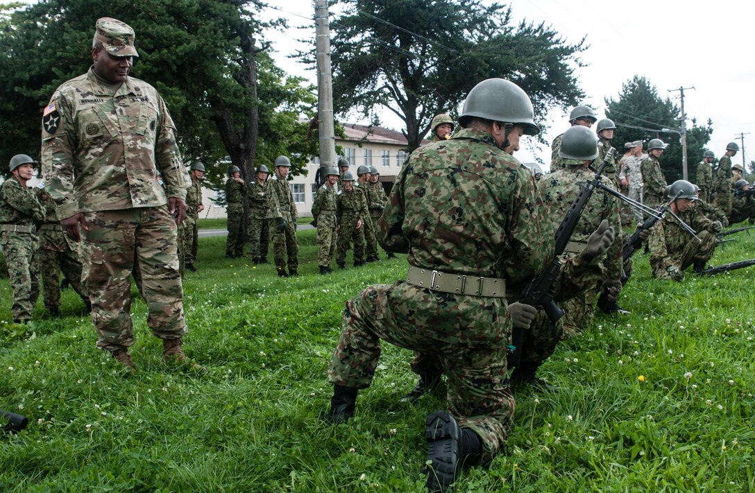 U.S. Army Sgt. Maj. Bennie Nunnally (left), senior enlisted advisor, Army Reserve Engagement Team-Japan, observes Japan Ground Self-Defense Reserve Component service members from the 18th Infantry Regiment, 11th Brigade, JGSDF Northern Army, learn how to use a Howa Type 89 Assault Rifle during a weapons familiarization training exercise conducted Sept. 10, 2016, in Camp Makomanai, Japan. Nunnally, a former drill instructor, complimented his JGSDF partners for their professionalism and discipline during the drill. Commonly referred as, “Buddy,” by JGSDF troops, the Type 89 is gas operated weapon that can fire up to 750 rounds per minute. It was designed with simplified operation and minimal number of parts due to the understanding that the complex structure and large number of parts often hindered the operation of its direct predecessor, the Type 64 Assault Rifle.  (Photo by Sgt. John L. Carkeet IV, U.S. Army Japan)