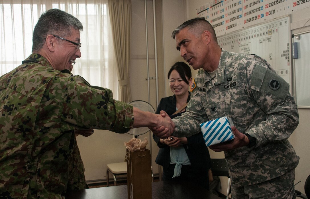 U.S. Army Col. Luis Pomales (right), director, Army Reserve Engagement Team-Japan, accepts a welcome gift from Japan Ground Self-Defense Force Col. Katsuya Takagi, director, Personnel Department, JGSDF Northern Army, Sept. 9, 2016, in Camp Sapporo, Japan. Pomales visited Camp Sapporo to meet with his JGSDF Reserve Component partners to learn more about their vision, mission, capabilities and organization. Pomales and Takagi also shared best practices on how to overcome their respective command’s manpower challenges and improve relations between Reserve Component service members and their civilian employers. (Photo by Sgt. John L. Carkeet IV, U.S. Army Japan)