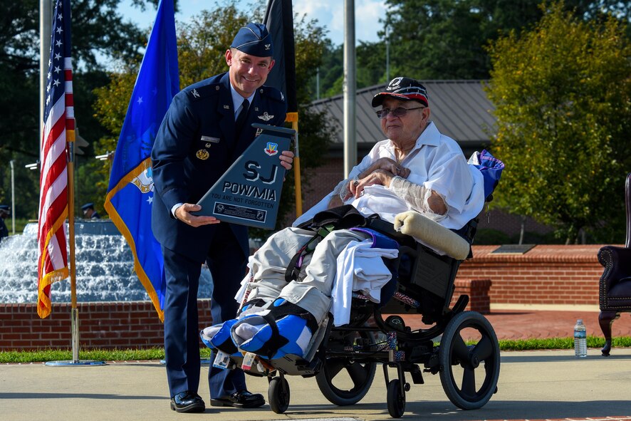 Col. Brian Armstrong (left), 4th Fighter Wing vice commander, presents Gaspar Gonzalez, a former Korean War Prisoner of War and U.S. Army Green Beret, with a tail flash, Sept. 15, 2016, at Seymour Johnson Air Force Base, North Carolina. Armstrong gave closing comments during the POW/MIA Remembrance ceremony and thanked Gonzalez for his service and his empowering story of survival and escape as a POW. (U.S. Air Force photo by Airman Shawna L. Keyes)