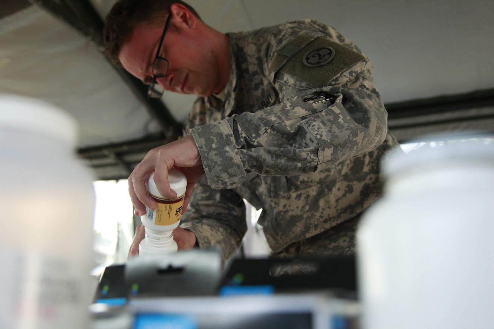 Army Sgt. Frisco Cleary, 396th Combat Support Hospital Company, condenses medications during a medical readiness exercise at San Padro, Guatemala, May 16. As of June, the Medical supply chain's national contracts team has saved $246.4 million through 45 contracts for generic drugs. Photo by Army. Spc. Keslon Brooks