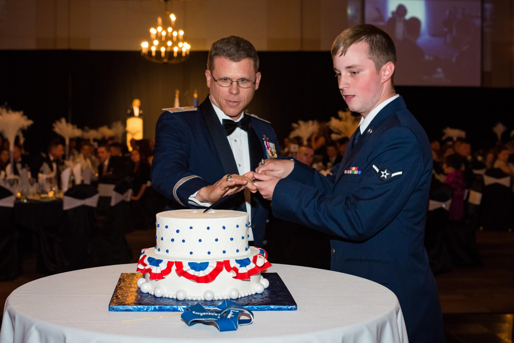 Brig. Gen. Steven J. Bleymaier, Ogden Air Logistics Complex commander, and Airman Adam Hornback, 75th Comptroller Squadron, cut the ceremonial birthday cake during the 2016 Air Force Ball at the Davis Convention Center, Layton, Utah, Sept. 16, 2016. It is tradition for the cake to be cut by the highest-ranking officer and the most junior-ranking Airman in attendance. (U.S. Air Force photo by R. Nial Bradshaw)