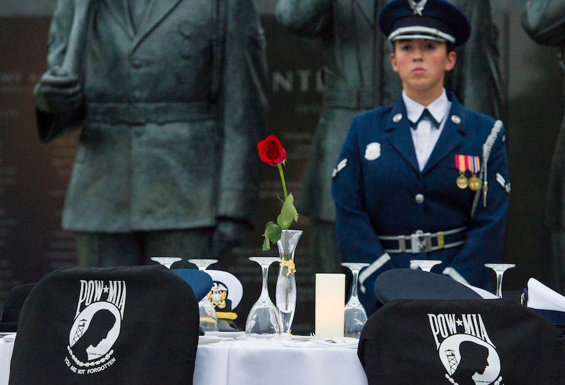 A U.S. Air Force Honor Guard Drill Team member watches over a Missing Man Table during the POW/MIA and Air Force Birthday event at the Air Force Memorial in Arlington, Va., Sept. 16, 2016. The table was set and surrounded by empty chairs to represent military members who are, or were, missing, along with a single rose to signify their lives. 