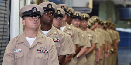 Chief Petty Officers with the Nuclear Power Training Unit Charleston stand in formation after receiving their gold anchor collar devices at a Chief Petty Officer Pinning Ceremony aboard the USS Yorktown in Charleston, South Carolina, Sept. 16, 2016. 
