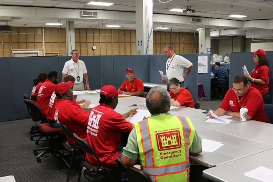 Chris Klein (L), U.S. Army Corps of Engineers, South Atlantic Division temporary housing program manager and Jon Wilson (R), a haul and install action officer from U.S. Army Engineering and Support Center Huntsville , give an in-brief to newly arrived Quality Assurance Representatives. QARs are deploying from throughout the Army Corps of Engineers in support of the Baton Rouge severe storms and flooding. The QARs are responsible for Manufactured Home Unit site inspection reports and inspecting the MHUs before they are occupied.