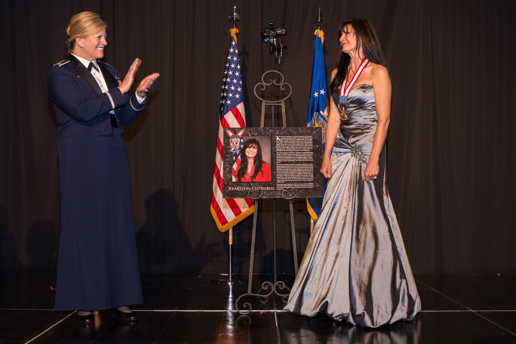 Kearston Cutrubus receives applause from 75th Air Base Wing Commander Col. Jennifer Hammerstedt during the 2016 Air Force Ball at the Davis Convention Center, Layton, Utah, Sept. 16, 2016. Cutrubus received the Community Wingman Award during the event for her staunch support of the Air Force and Hill Air Force Base. (U.S. Air Force photo by R. Nial Bradshaw)