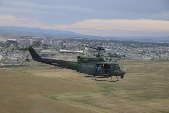 A UH-1N Iroquois helicopter from 40th Helicopter Squadron flies away from Malmstrom Air Force Base, Mont. and over the city of Great Falls Sept. 17, 2016 Thirty-one 40th HS spouses were flown as part of a spouse appreciation and orientation flight. (U.S. Air Force photo/Staff Sgt. Delia Marchick)