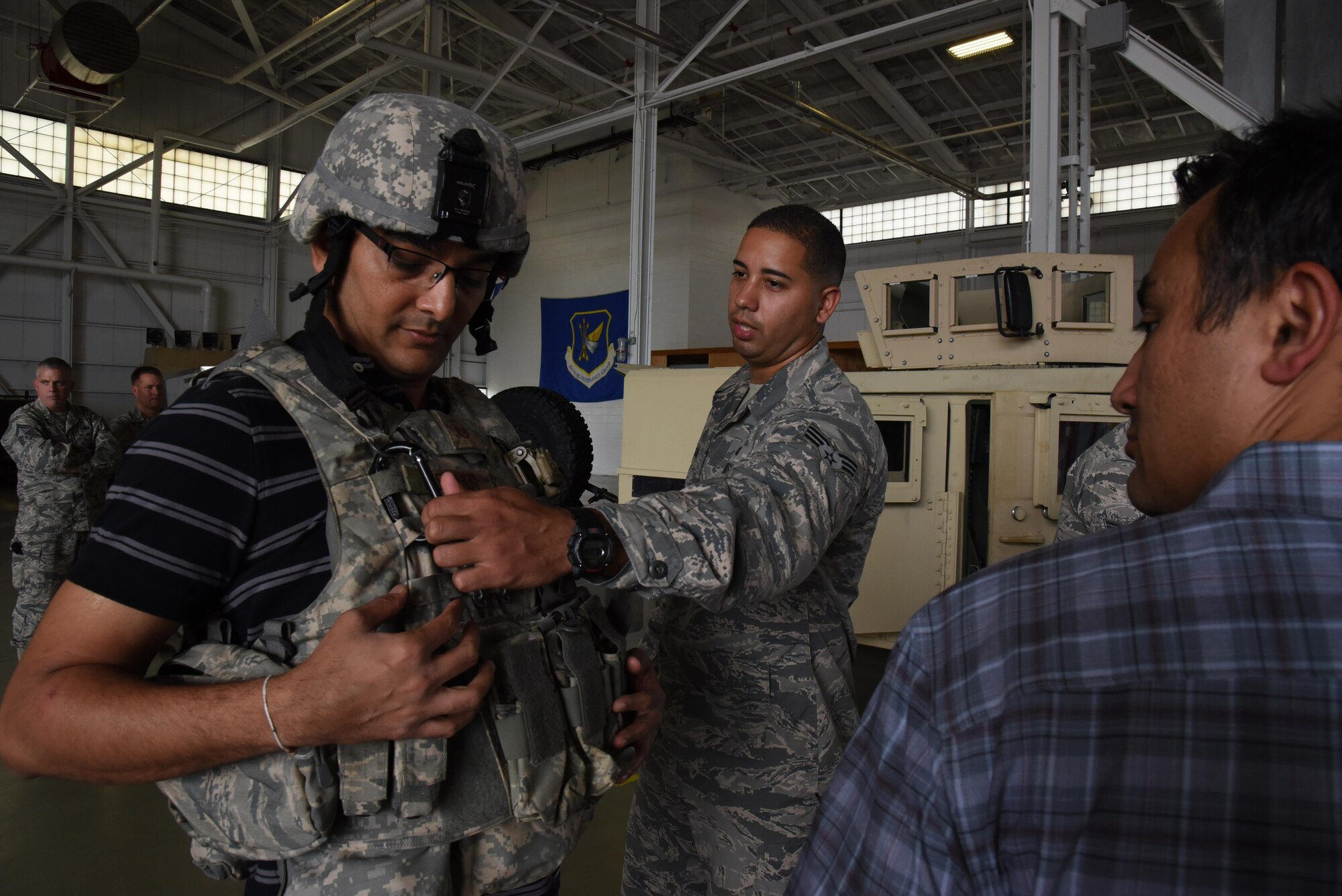 A 514th Security Forces Squadron member explains about the flak vests to a civilian guest during Employer Appreciation Day held here Saturday. Eighty employers of 514th Air Mobility Wing reservists participated in the annual event. The Freedom Wing guests flew on an C-17 Globemaster III and KC-10 Extender air refueling training mission, visited work stations and spoke with wing leadership. (U.S. Air Force photo/Senior Airman Terrence Clyburn) 