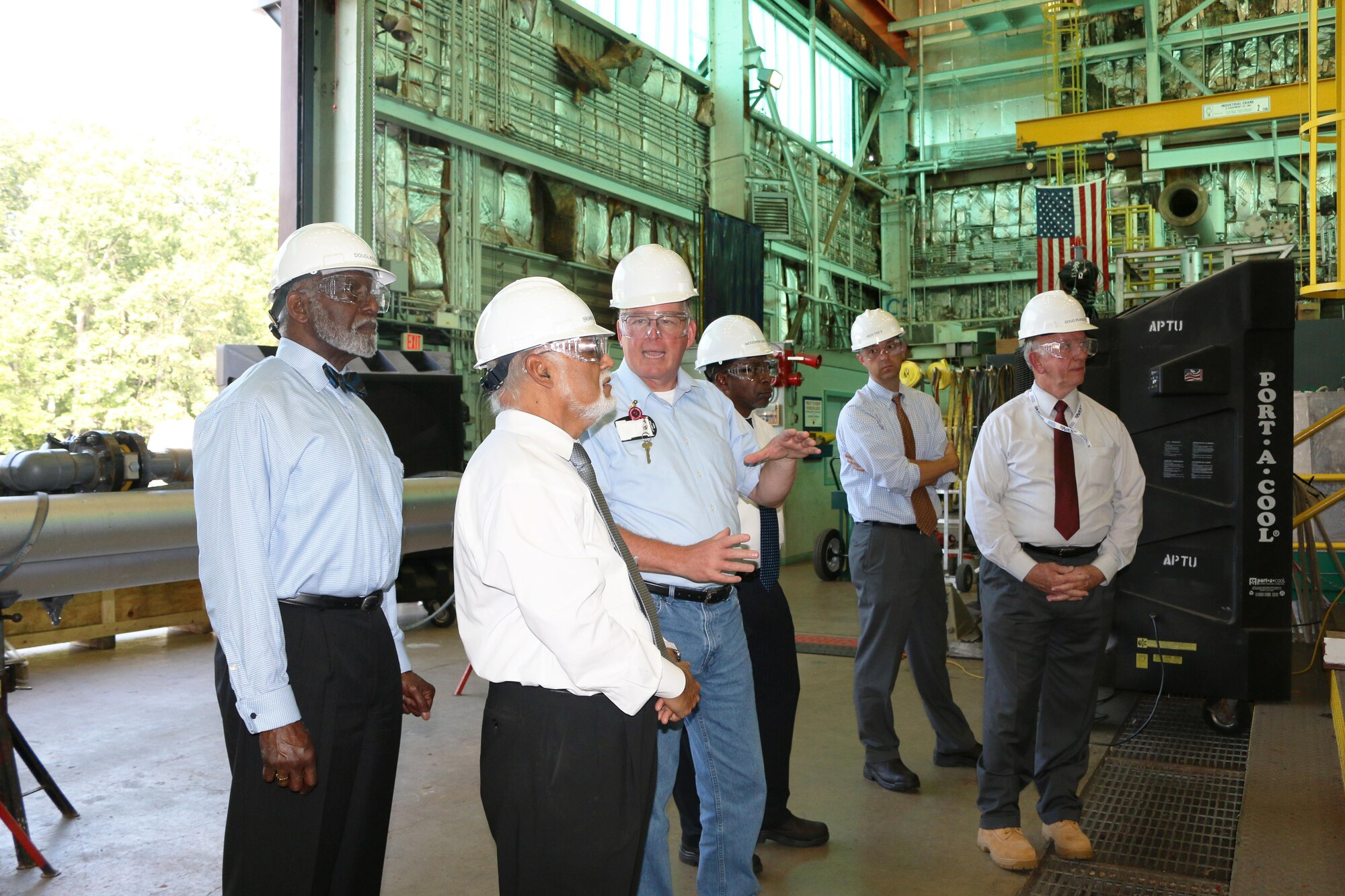 Dr. Doug Garrard, AEDC senior staff engineer, explains testing operations in the Aerodynamic and Propulsion Test Unit at the Complex to members of the National Aerospace Solutions, LLC Technical Advisory Board Sept. 9, 2016. APTU is a blow-down, true temperature and pressure test facility designed for testing the performance, operability and durability of supersonic and hypersonic missile scale flight system hardware including propulsion systems and materials. The NAS TAB members toured several test facilities with the AEDC Test Operations and Sustainment contractor. Pictured left to right is Dr. Wesley Harris, with Massachusetts Institute of Technology; Dr. Krishan Ahuja, with Georgia Institute of Technology; Garrard; Dr. Woodrow Whitlow, NAS technical director; Dr. Edward White, Texas A&M University; and Doug Pearson, NAS deputy general manager. (U.S. Air Force photo/Holly Peterson)