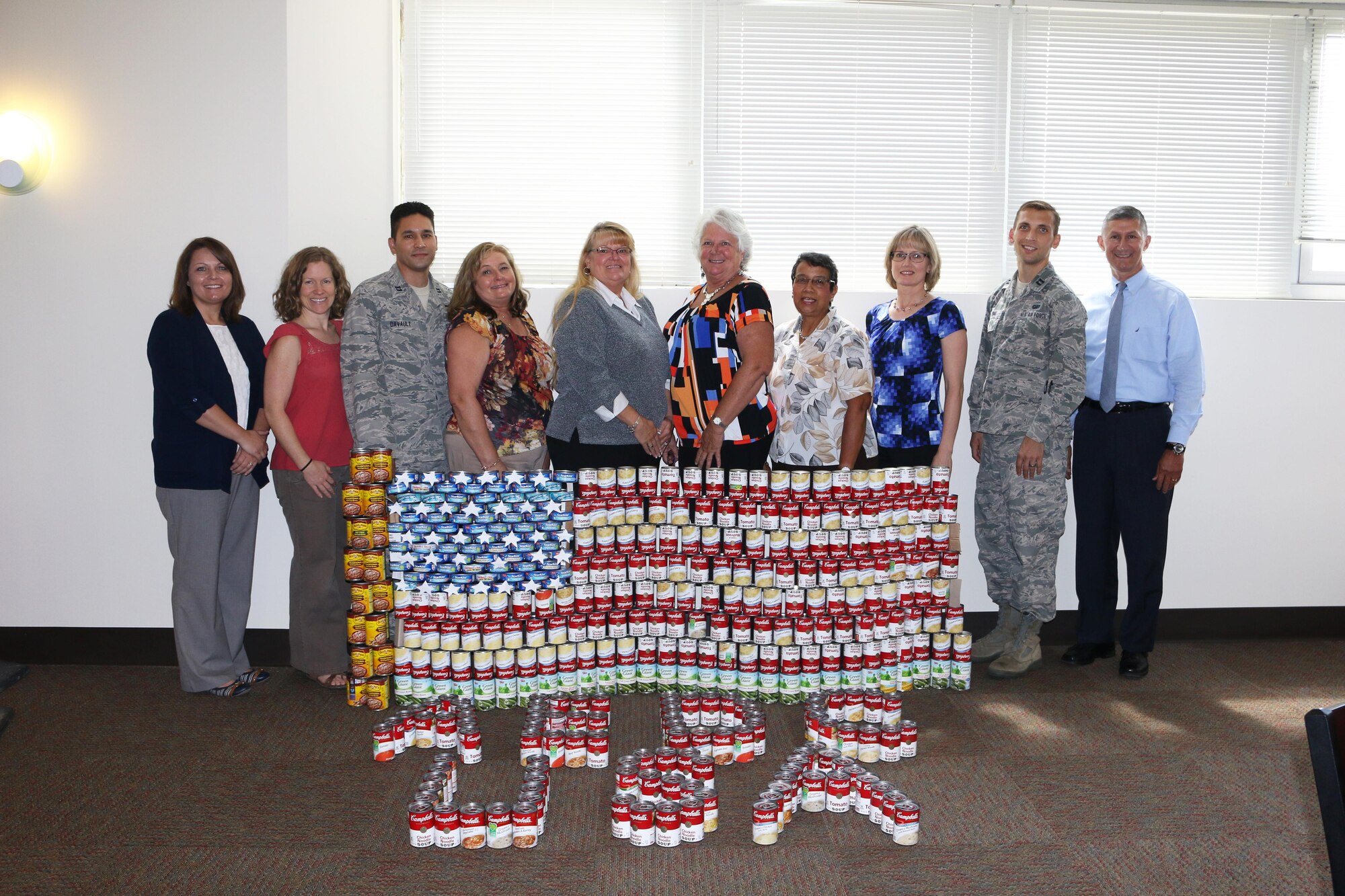 Feds Feed Families volunteers at AEDC stand with the “Can-Struction” display made from canned food donations to resemble the American flag, Aug. 31, 2016. The donations, totaling 1,579 pounds, were given to three local Good Samaritan agencies. Pictured left to right are Lalonnie Saltzman, Shannon Allen, Capt. Michael Davault, Peggy Proffitt, Pamela Anderson, Judy Mohler, Josie Henley, Becky Morris, Capt. Jonathan Diaz and Kenneth Jacobsen. (U.S. Air Force photo/Holly Peterson) 
