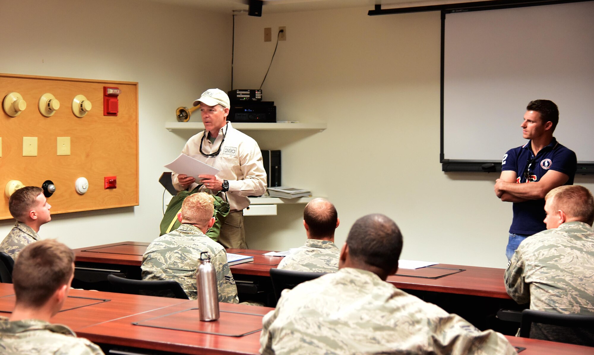 PETERSON AIR FORCE BASE, Colo. - Rob Powers, founder of the American300 group, speaks to Airmen at the base fire station with Troy Dumais, four-time U.S. Olympic diver, as part of the tour launching their new program “Dive into Service” at Peterson Air Force Base, Colo., Sept. 12, 2016. The program is geared toward bringing U.S. Olympic Dive Team athletes and military members together to share experiences in dealing with high-pressure situations. (U.S. Air Force photo by Staff Sgt. Amber Grimm)