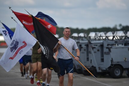 Chief Master Sgt. Mark Cantrell, from the 628 Security Forces Squadron, and senior enlisted leaders from each service carry the POW/MIA flag along with flags from each branch of service at Nose Dock 2, September 16, 2016, at Joint Base Charleston, South Carolina.  Every year, members from the base participate in a 24-hour vigil run, a luncheon to honor prisoners of war and those that are missing in action, as well as a formal retreat ceremony.