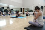 Holly Middleton (right), yoga instructor, teaches vinyasa style yoga Sept. 14, 2016 during a class at the Joint Base San Antonio-Randolph Fitness Center. Although class attendees follow the direction of the instructor, the experience of each person doesn’t have to be the same. Each pose can be modified based upon age, experience or physical limits

