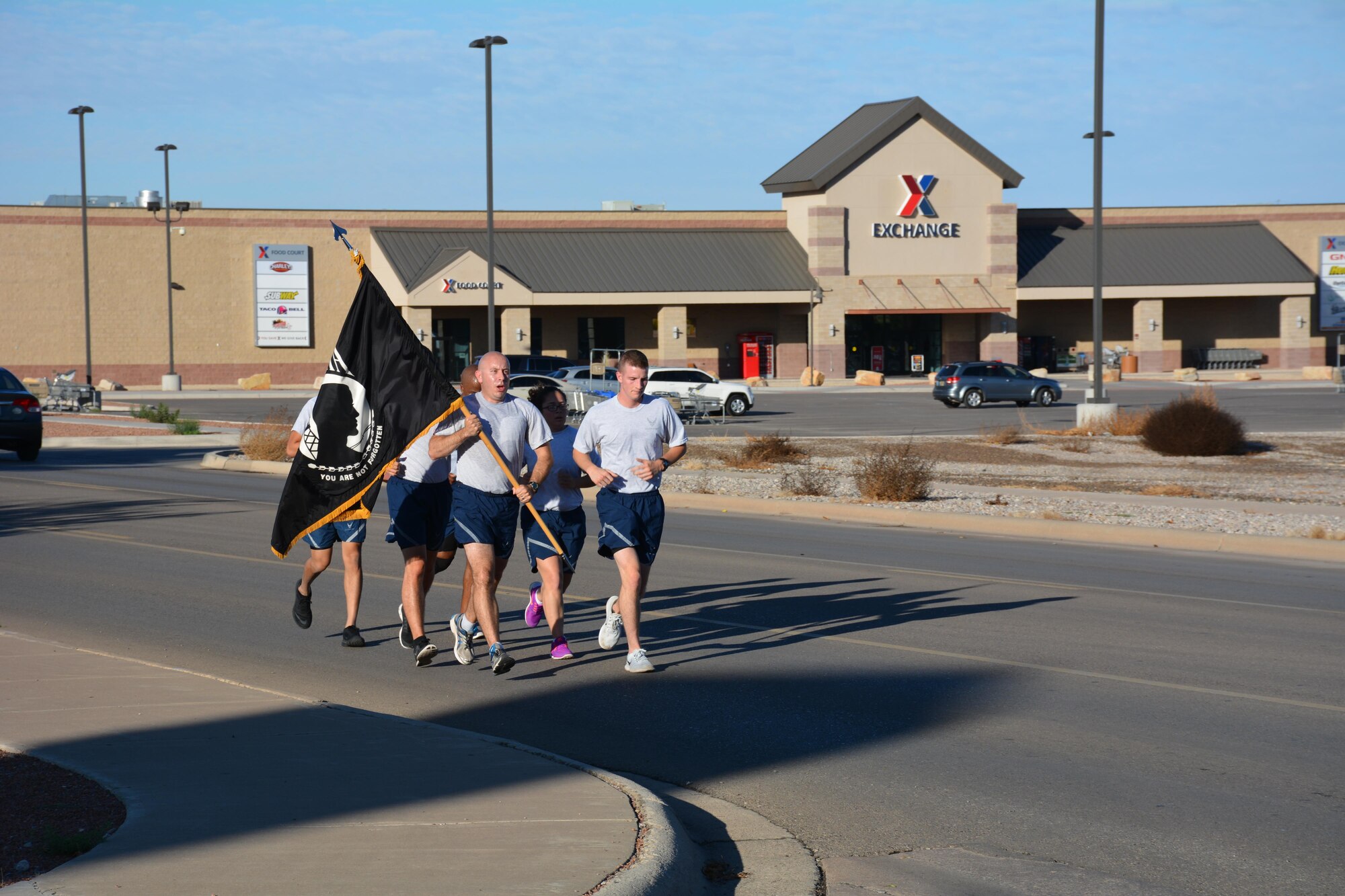 Holloman Airmen run with the POW/MIA guide-on during the annual POW/MIA remembrance run at Holloman Air Force Base, N.M.,on Sept. 16, 2016. The run, which lasted 24 hours and involved units from all over Holloman, was in remembrance of prisoners of war and those still missing in action. (U.S. Air Force photo by Staff Sgt. Warren Spearman)