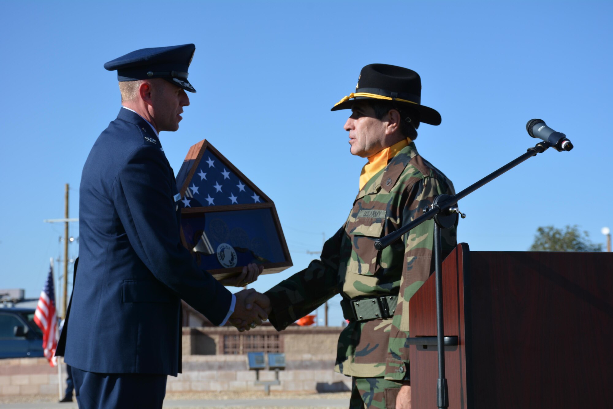 Colonel Ryan Craycraft, the 49th Wing vice commander, presents a shadow box to Staff Sgt. Darrell Mond, U.S. Army veteran, and guest speaker, at the POW/MIA remembrance ceremony at Holloman Air Force Base, N.M., on Sept. 16, 2016. The ceremony, which was in remembrance of prisoners of war and those still missing in action, was part of Holloman’s POW/MIA commemoration. (U.S. Air Force photo by Staff Sgt. Warren Spearman)