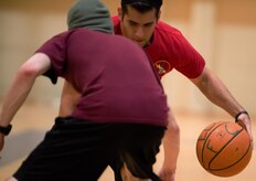 Senior Airman Alexis Colón, 301st Intelligence Squadron intelligence analyst dribbles past an opposing player before driving in for a lay-up at the Elmendorf Fitness Center, Sept. 15. Basketball courts are available both at Buckner Physical Fitness Center and EFC, though the tournaments and events take place only a BPFC. 