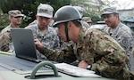 Army Maj. Donald Kim (left), U.S. Army liaison officer for the Japan Ground Self-Defense Force Eastern Army and Central Readiness Force, and JGSDF Sgt. 1st Class Yamanashi Yoshihiro (right), escort noncommissioned officer-in-charge, 2nd Company, 34th Infantry Regiment, JGSDF Eastern Army, finalize the route for a vehicle convoy Sep. 4, 2016, in Kakegawa, Japan. The U.S. Army and JGSDF bilateral convoy simulated a humanitarian relief mission as part of the Shizuoka Prefecture Comprehensive Disaster Drill. The drill demonstrated how a diverse collection of local, regional, national and international organizations can pool their respective resources to effectively respond to a major disaster. In addition to coordinating convoy routes, the contingent of U.S. Army troops collaborated with their JGSDF counterparts to provide casualty care, establish mobile communication site and set up supply distribution points.