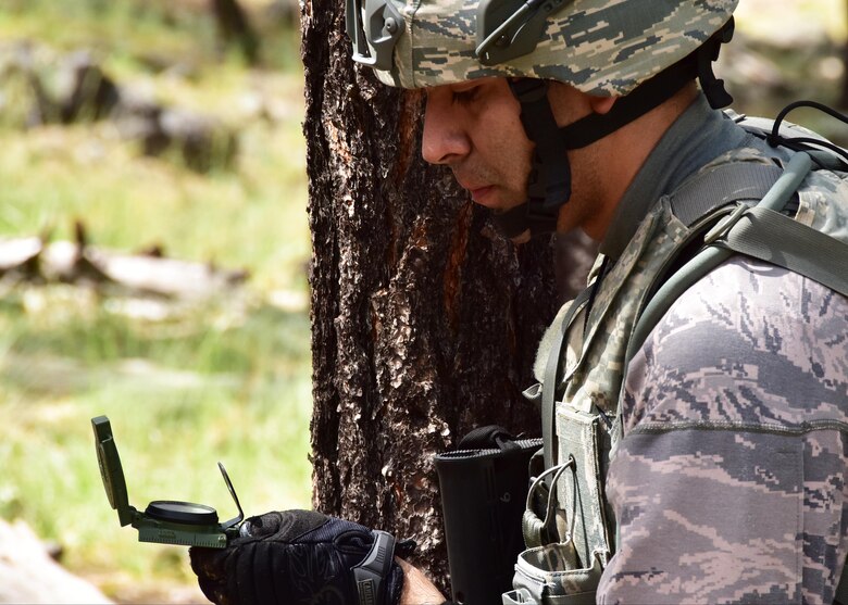 Senior Airman Steven Mendivil, 944th Security Forces Squadron fire team member, determines direction with his compass Sept. 9 during combat training at Camp Navajo, Arizona Army National Guard facility in Bellemont Arizona. (U.S. Air Force photo by Tech. Sgt. Barbara Plante)