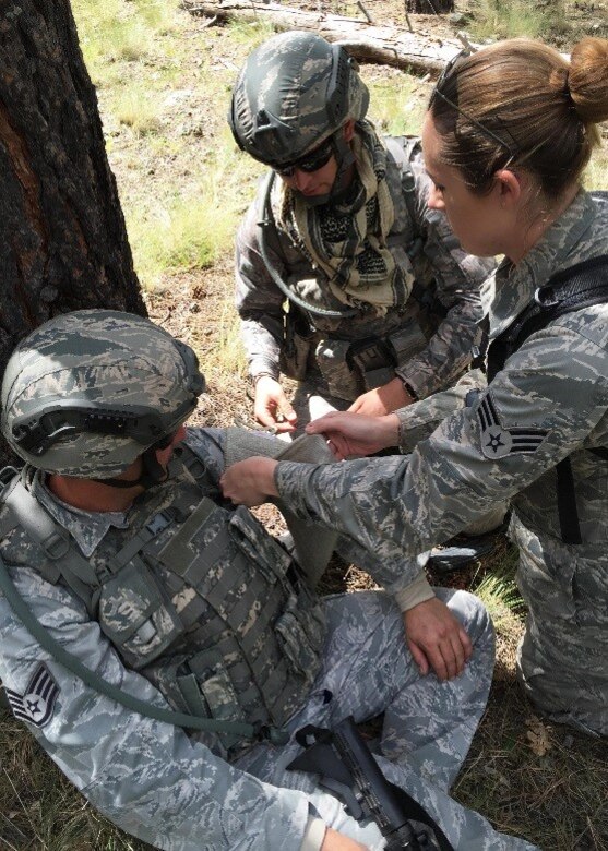 Senior Airman Ashlynd Vaughn, 944th Aeromedical Staging Squadron medical technician, instructs 944th Security Forces fire team members on how to care for a wound Sept. 10 at Camp Navajo, Arizona Army National Guard facility in Bellemont Arizona. (U.S. Air Force photo by Col. Paul Theisen)