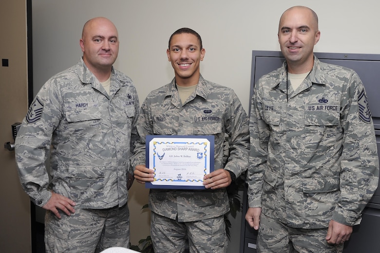 Master Sgt. Joseph Hardy, 50th Network Operations Group first sergeant, and Senior Master Sgt. Allen Levie, 50th Operations Group first sergeant, present Airman 1st Class Julius W. DeBias with the August 2016 Diamond Sharp Award at Schriever Air Force Base, Colorado, Monday, Sept. 19, 2016. The intent of the Diamond Sharp Award is to recognize individuals who demonstrate outstanding performance and professionalism on a daily basis. 

As a communications technician in the 3rd Space Operations Squadron, DeBias fixed 23 software, hardware and account malfunctions which led directly to his section's “Outstanding” Information Assurance inspection rating. He also meticulously de-conflicted the loss of Terrestrial Critical Control Circuit connectivity on multiple occasions, which provided secure messaging about satellite anomalies between Schriever Air Force Base and the Ft. Detrick, Maryland, communication hub.  Lastly, DeBias volunteered at the Eagle's Nest Ranch “Healing Horses for the Armed Forces” program and raised funding to support the new Rocky Mountain Fisher House in Denver. (U.S. Air Force photo/Christopher DeWitt)