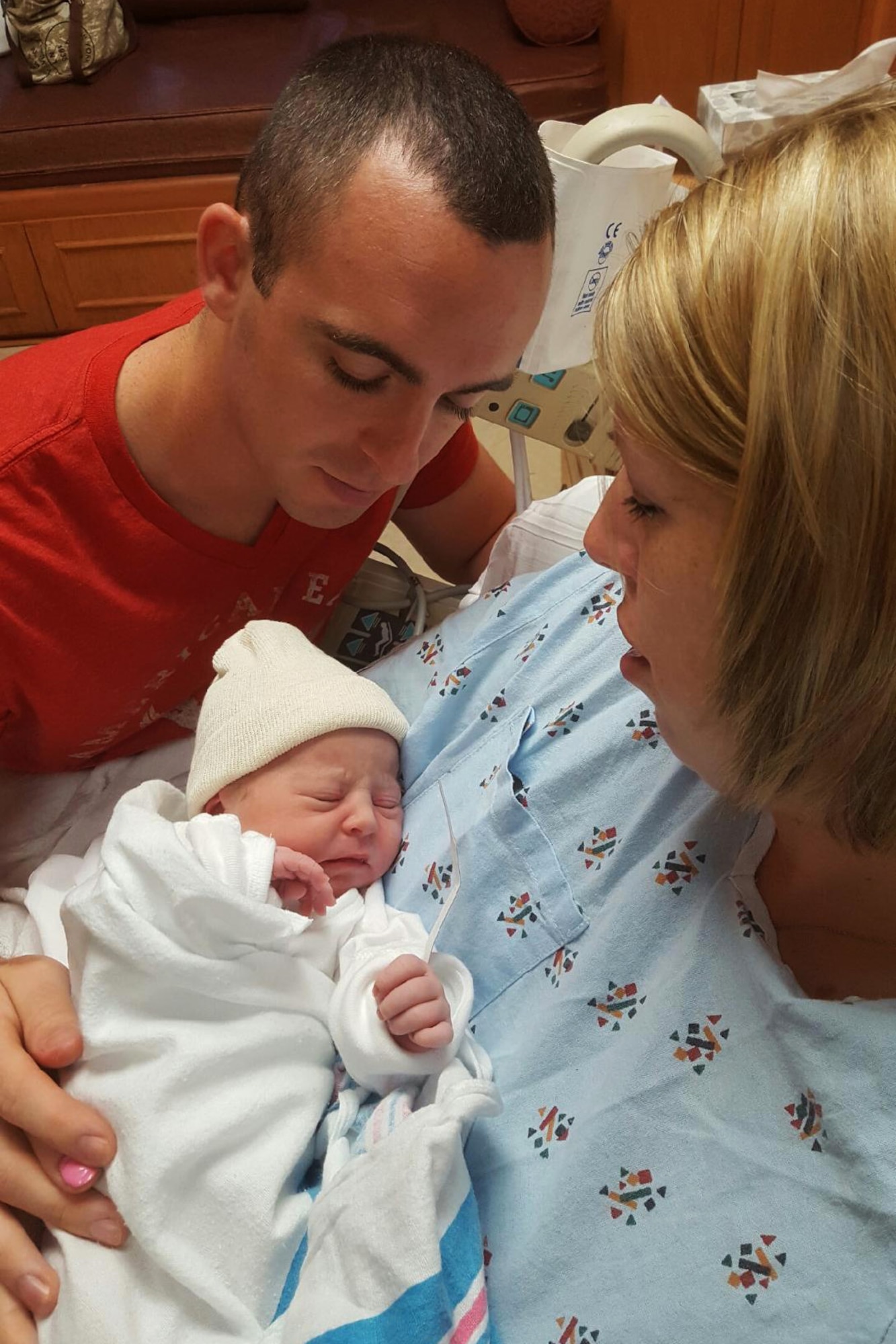 Airman 1st Class Travis Beihl, 81st Training Wing Public Affairs photojournalist, and wife Erin hold their daughter Mackenzie in the mother/baby suite at Memorial Hospital in Gulfport, Miss. Aug. 22, 2016. Mackenzie was born at 10:29 a.m. with a weight of 6 pounds, 5 ounces and measured 17 and 3/4 inches long. (U.S. Air Force photo by Airman 1st Class Travis Beihl/Released)