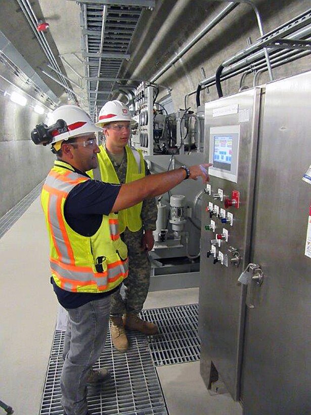 Cadet Sean Kasprisin, a third-year student in the University of Wyoming ROTC, learns about the Quality Assurance process at the Folsom Dam auxiliary spillway project from Daniel Figueroa, project engineer with the U.S. Army Corps of Engineers Sacramento District. 