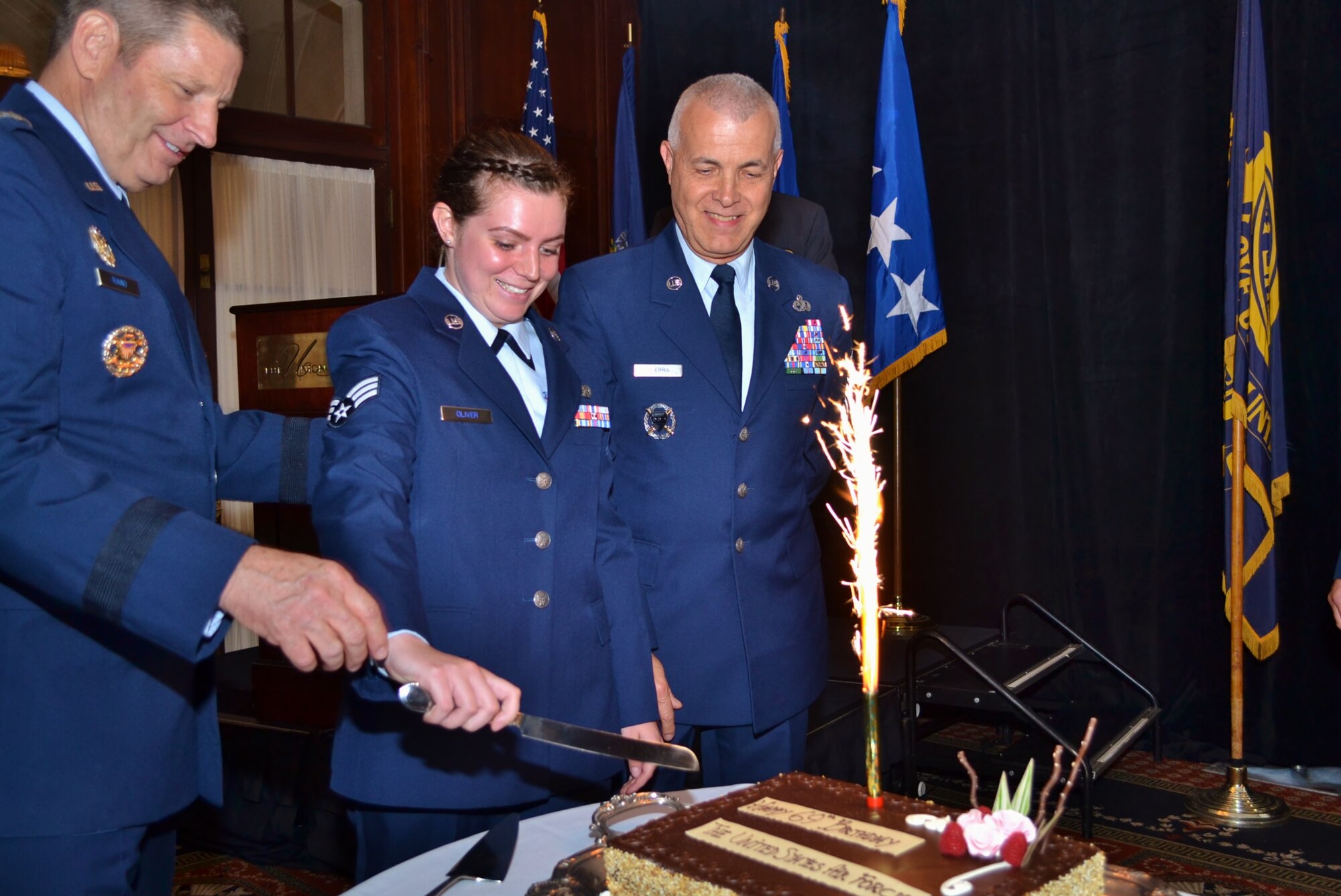 Gen. Robin Rand, Air Force Global Strike Command commander, Barksdale Air Force Base, Louisiana, assists as the youngest and oldest Airmen in attendance cut the cake during the Air Force birthday celebration hosted by and held at the Union League of Philadelphia, Sept. 16, 2016. This year the Air Force boasts 69 years as a military component. (U.S. Air Force photo by Tech. Sgt. Andria Allmond)