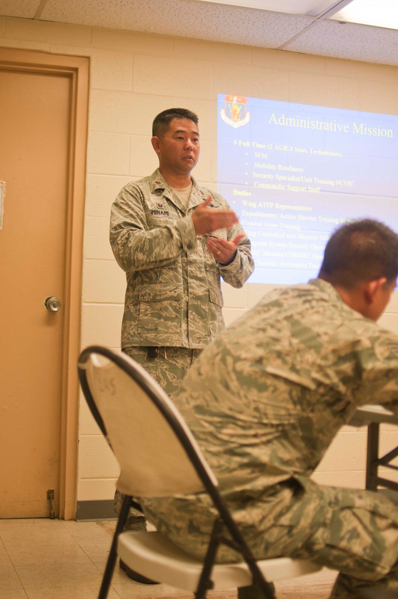 U.S. Air Force Major Dane Minami commander of the 154th Security Forces Squadron from the Hawaii Air National Guard, briefs families about the unit mission and about deployments on Joint Base Pearl Harbor-Hickam, Hawaii on Aug. 7, 2016. The 154th SFS has one of the highest deployment rates in the HIANG. (U.S. Air National Guard photo by Airman 1st Class Stan Pak/released)