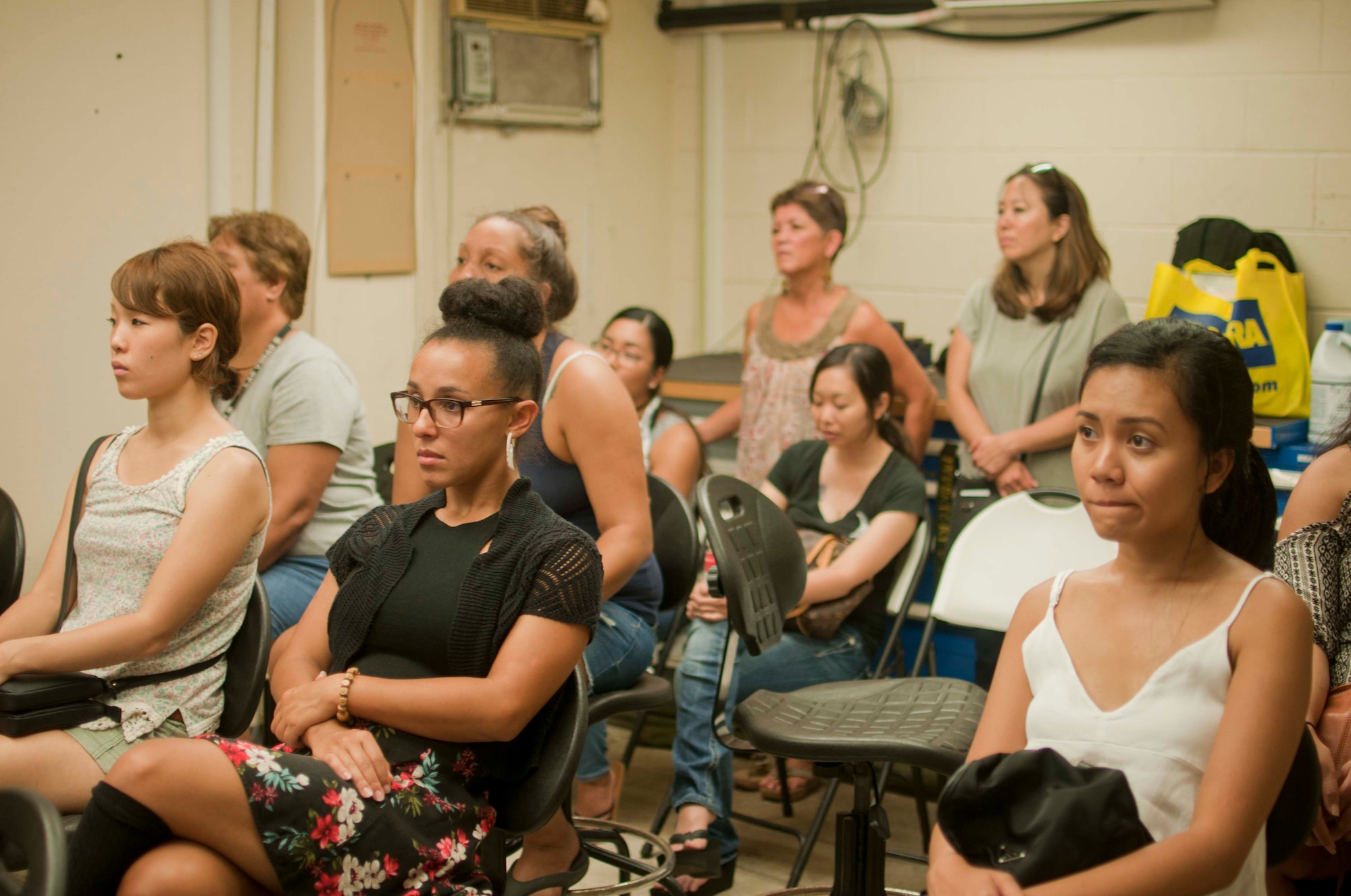 Hawaii Air National Guard 154th Security Forces Squadron family members, attend a brief about the unit's mission and deployments for family day on Joint Base Pearl Harbor-Hickam, Hawaii on Aug. 7, 2016. The 154th SFS has one of the highest deployment rates in the HIANG. (U.S. Air National Guard photo by Airman 1st Class Stan Pak/released)