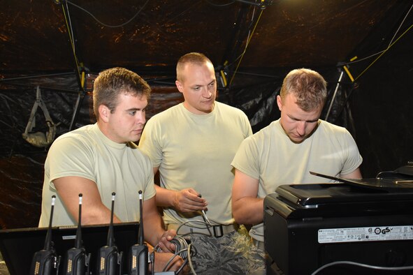 Airman 1st Class Michael Wedeward, left, Staff Sgt. Cory Sachtjen, center, and 1st Lt. Jeffrey Rutkowski, communications specialists for the Wisconsin Air National Guard's 115th Fighter Wing provide Joint Incident Site Communications Capability for the 2016 East Bay Stand Down Innovative Readiness Training exercise Sept. 16, 2016. The four day event allowed Guard and Reserve members from four service branches to meet critical training requirements while providing medical, dental and optometry care to the medically underserved, homeless veteran community of California's East Bay Region. (U.S. Air National Guard photo by Master Sgt. Paul Gorman/Released) 