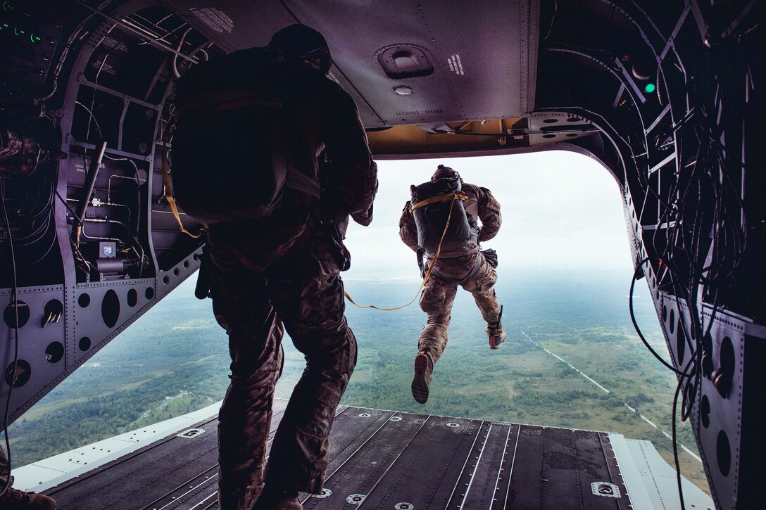 An airman jumps from the back of an Army CH-47 Chinook helicopter while participating in an air assault and airborne training operation at Fort Drum, N.Y., Sept. 10, 2016. Air National Guard photo by Staff Sgt. Ryan Campbell