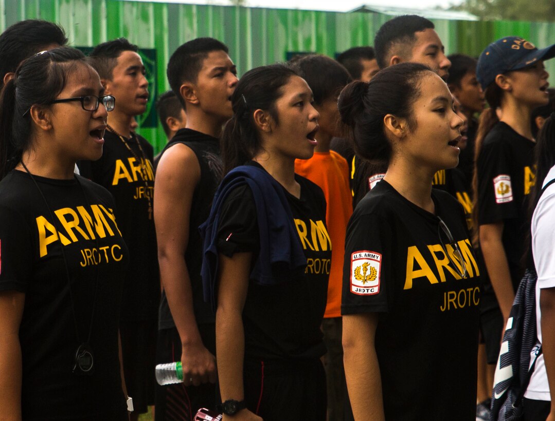 Students in the Junior Reserve Officer Training Corps sound off in formation after a 5K race at Taga beach on the Island of Tinian, Sept. 17, 2016. Marines and Sailors participating in Exercise Valiant Shield 16 hosted the race, allowing them to get to know Tinian locals. VS16 is a biennial, U.S.-only, field training exercise with a focus on integration of joint training among U.S. forces. This training enables real-world proficiency in sustaining joint forces through detecting, locating, tracking and engaging units at sea, in the air, on land, and in cyberspace in response to a range of mission areas. (U.S. Marine Corps photo by Lance Cpl. Kelsey Dornfeld)