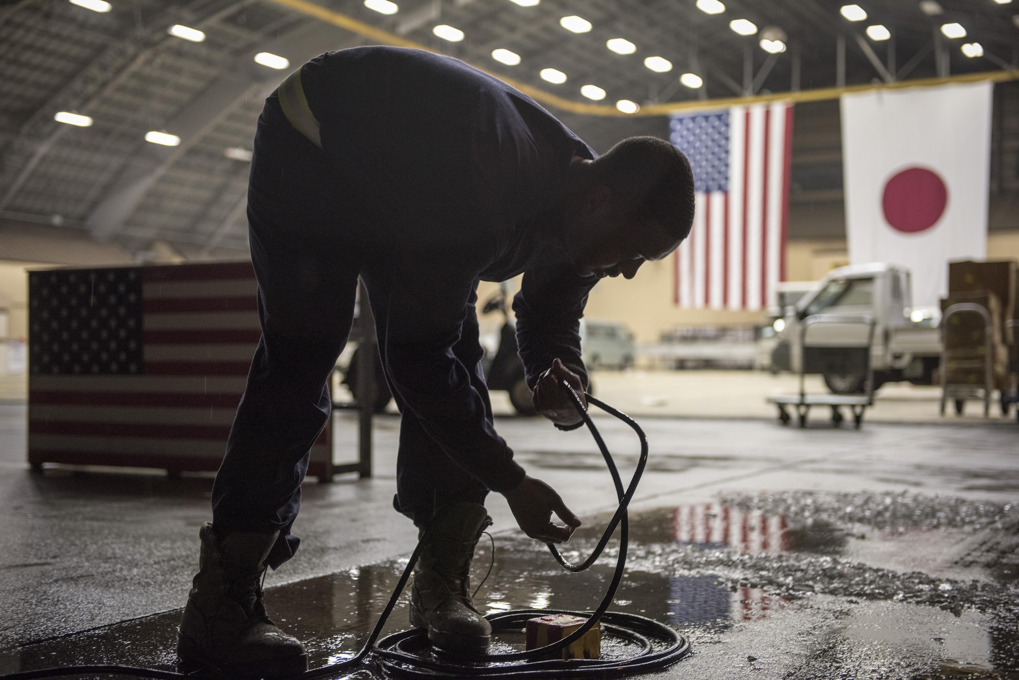 An Airman with the 374th Civil Engineer Squadron electrician shop coil cords used during the 2016 Japanese-American Friendship Festival at Yokota Air Base, Japan, Sept. 18, 2016. The festival is located on part of Yokota’s flightline and brings more than 100,000 people on base every year. (U.S. Air Force photo by Staff Sgt. Cody H. Ramirez/Released)