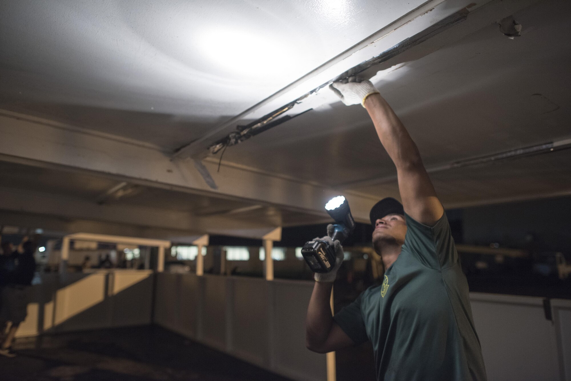 An Airman with the 374th Civil Engineer Squadron structures shop inspects the roof of a booth after the 2016 Japanese-American Friendship festival at Yokota Air Base, Japan, Sept. 18, 2016. The 374 CES structures shop broke down multiple booths at the conclusion of the festival, assisting to return the flightline to full operational status. (U.S. Air Force photo by Staff Sgt. Cody H. Ramirez/Released)
