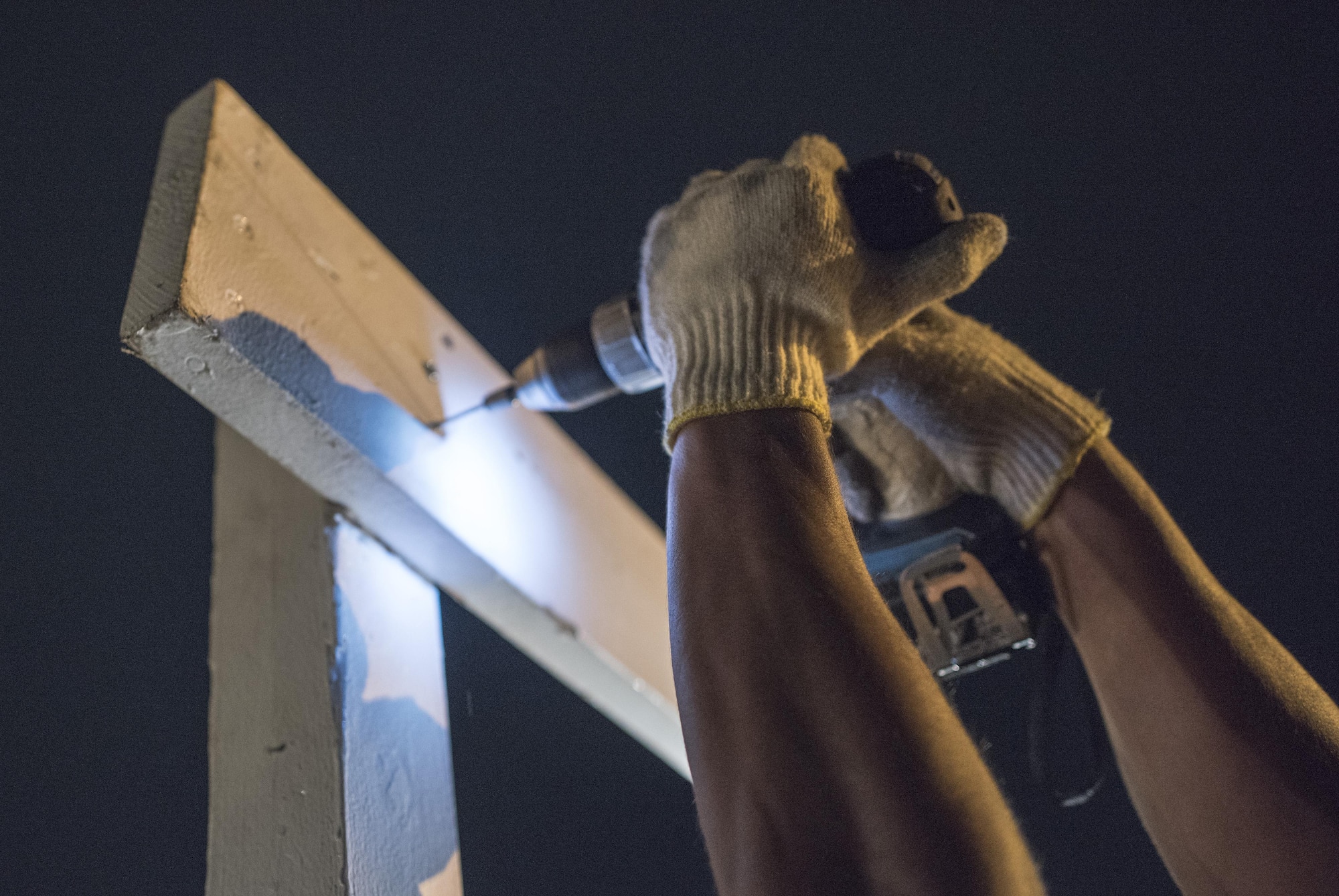 An Airman with the 374th Civil Engineer Squadron structures shop unscrews support beams of a booth after the 2016 Japanese-American Friendship festival at Yokota Air Base, Japan, Sept. 18, 2016. The 374 CES structures shop broke down multiple booths at the conclusion of the festival, assisting to return the flightline to full operational status. (U.S. Air Force photo by Staff Sgt. Cody H. Ramirez/Released)