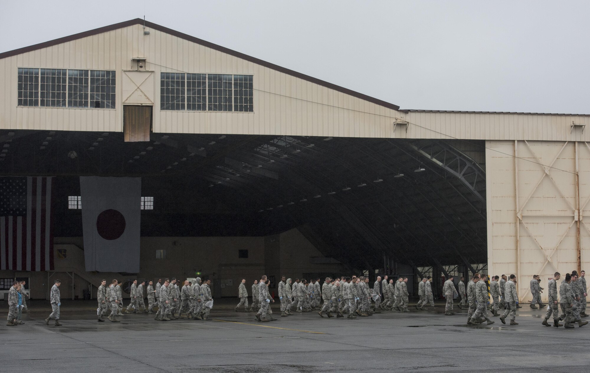 Airmen conduct a foreign-debris walk over the flightline at Yokota Air Base, Japan, Sept. 19, 2016. Airmen spread throughout areas of the base to pick up foreign debris left over by the 2016 Japanese- American Friendship Festival, which attracted more than 135,000 people to the base. (U.S. Air Force photo by Staff Sgt. Cody H. Ramirez/Released)