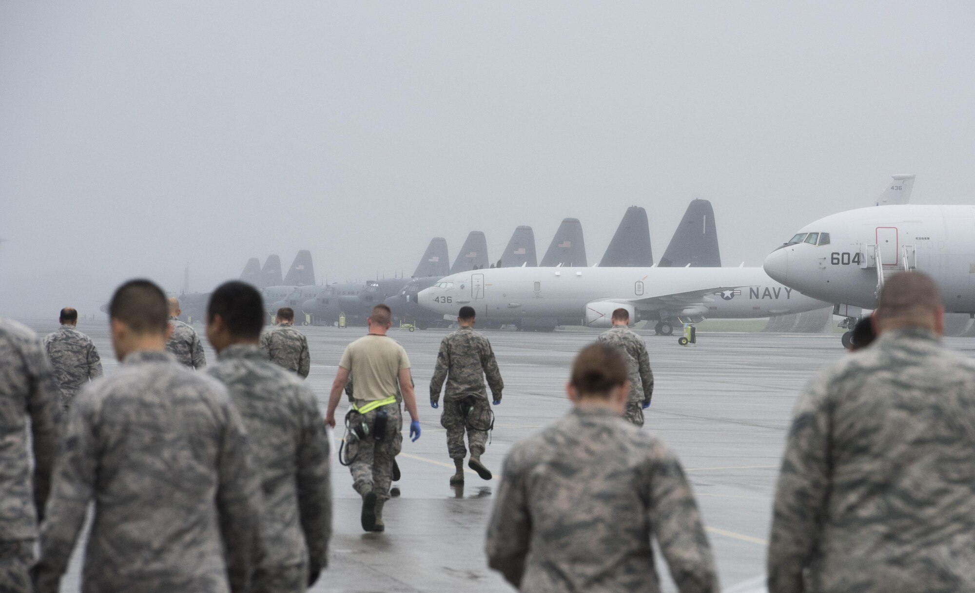 Airmen conduct a foreign-debris walk over the flightline at Yokota Air Base, Japan, Sept. 19, 2016. Airmen spread throughout areas of the base to pick up foreign debris left over by the 2016 Japanese- American Friendship Festival, which attracted more than 135,000 people to the base. (U.S. Air Force photo by Staff Sgt. Cody H. Ramirez/Released)