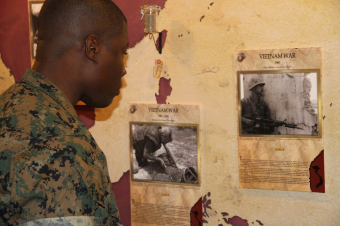 A Marine looks at a new display that shows off 3rd Marine Division history, Friday, Sept. 16, 2016, at Camp Courtney, Okinawa. 