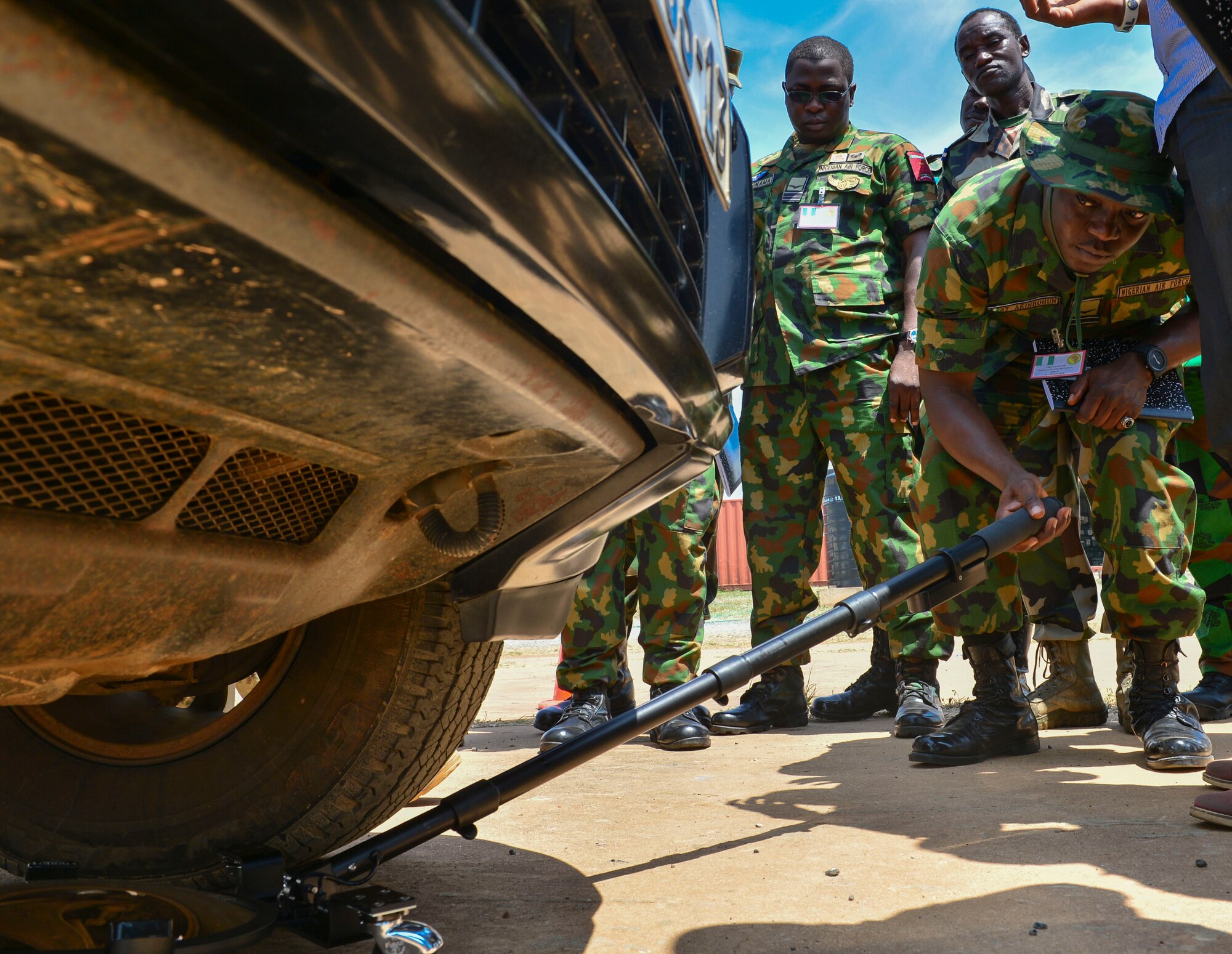 Nigerian air force squadron leader Sunkanmi Akinbohun, inspects a vehicle during the entry control familiarization portion of African Partnership Flight Ghana, Sept. 13, 2016, in Air Base Accra, Ghana. APF provides partner nations the opportunity to improve proficiency and readiness in key mission areas such as expeditionary airbase defense. (U.S. Air Force Staff Sgt. Stephanie Longoria)