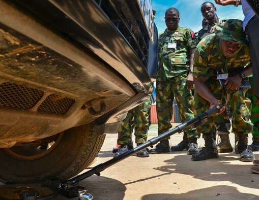 Nigerian air force squadron leader Sunkanmi Akinbohun, inspects a vehicle during the entry control familiarization portion of African Partnership Flight Ghana, Sept. 13, 2016, in Air Base Accra, Ghana. APF provides partner nations the opportunity to improve proficiency and readiness in key mission areas such as expeditionary airbase defense. (U.S. Air Force photo/Staff Sgt. Stephanie Longoria)