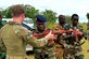 Staff Sgt. Jake Van Dyke (left), a 435th Security Forces Squadron contingency response fire team member, helps a Benin airman with his weapon during the African Partnership Flight in Accra, Ghana, Sept. 14, 2016. APF is a transparent working environment between U.S. and African partner nations that builds trust and cooperation to achieve common solutions. (U.S. Air Force photo/Staff Sgt. Stephanie Longoria)
